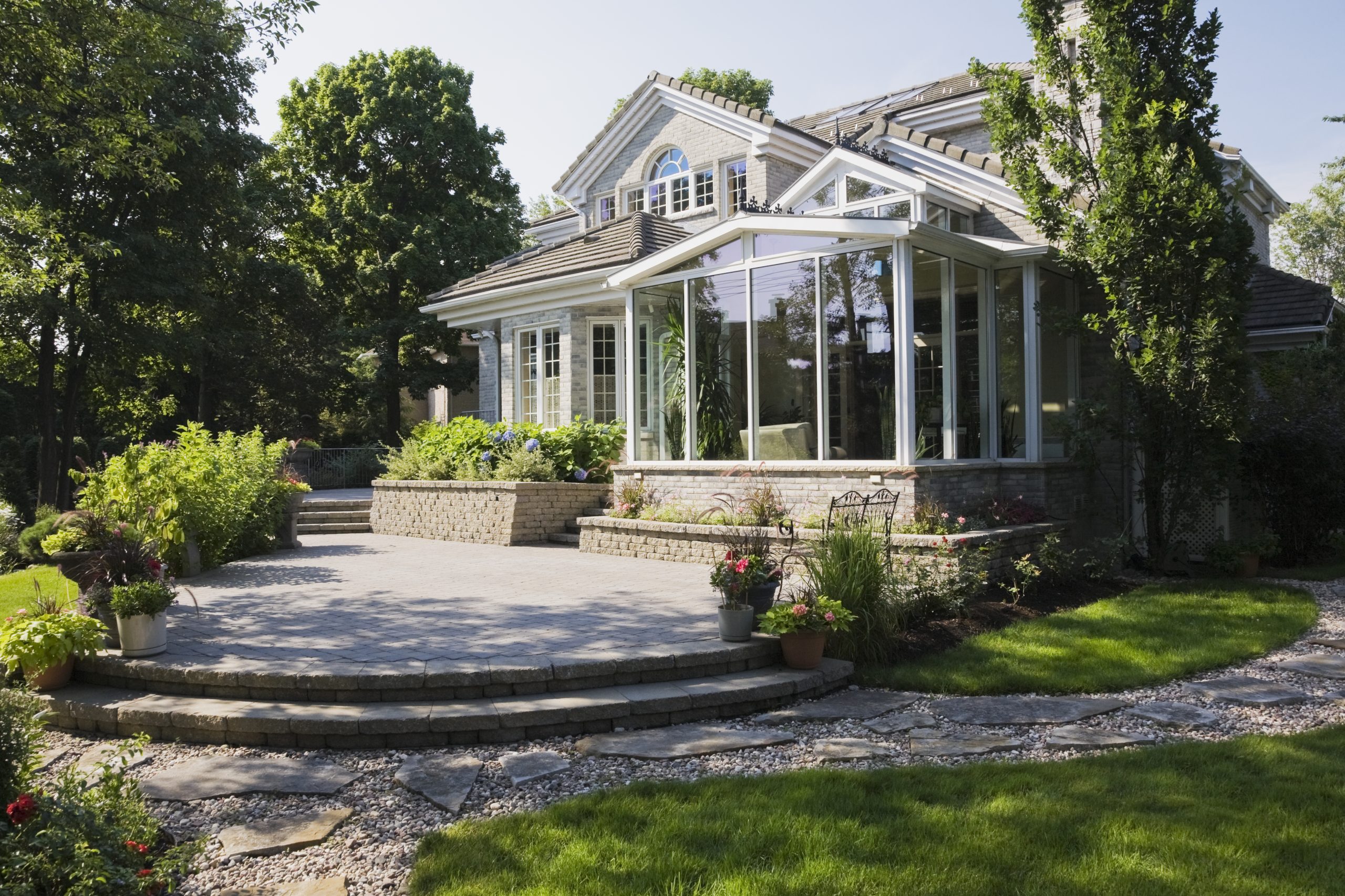 Paver patio with curved steps behind a Delaware home