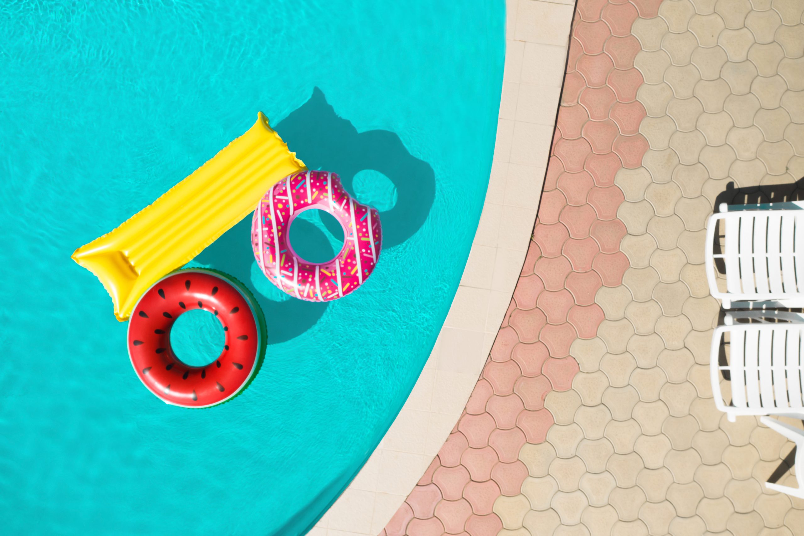 Inground pool with floats on a sunny day